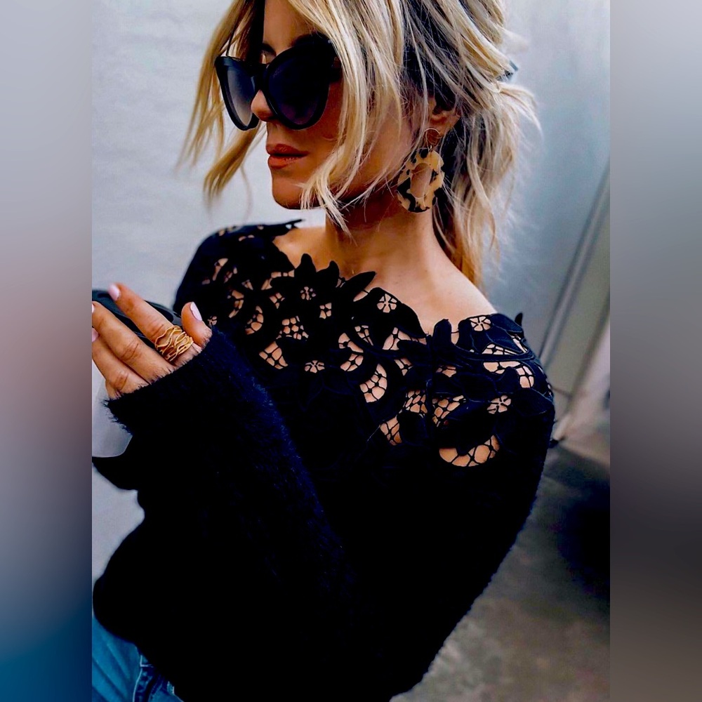 Gorgeous black sweater with floral lace embellishment. Very GLAM!